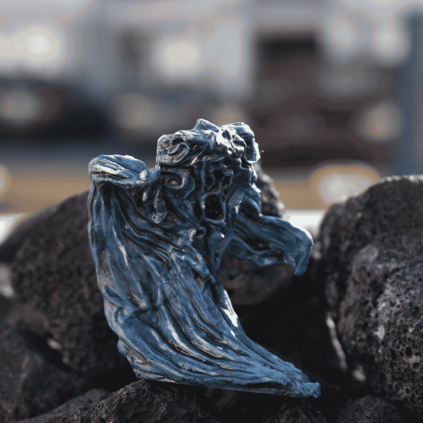 Hand-painted Water Elemental miniature in flowing blue tones, posed atop dark volcanic rocks with a swirling aquatic form.