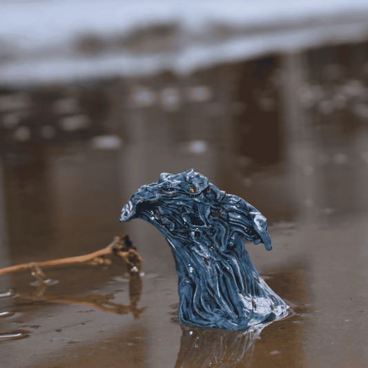 Water Elemental fantasy miniature emerging from reflective shallow water, with sculpted currents and glimmering paint details